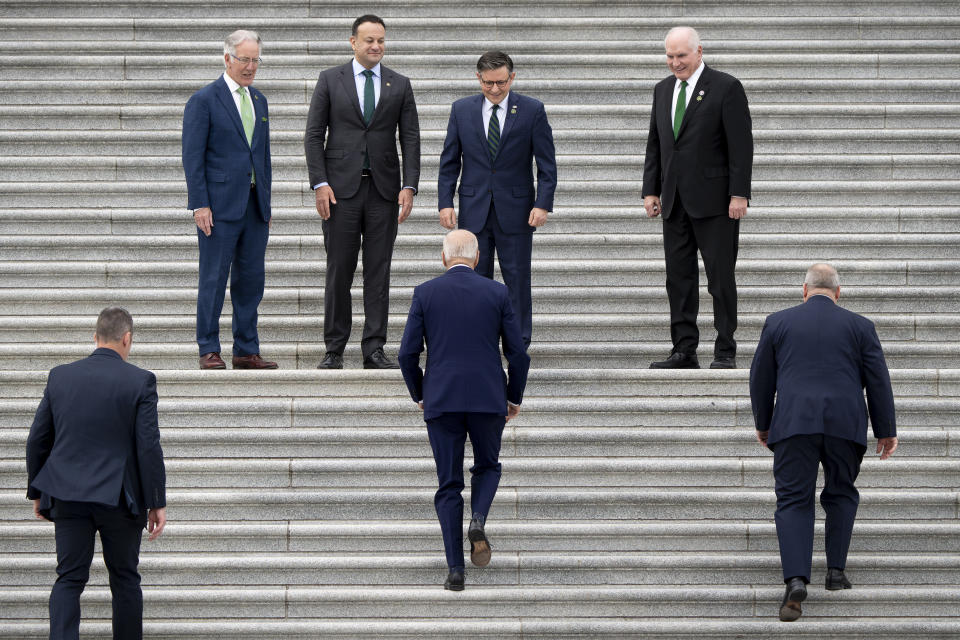 President Joe Biden, center, climbs the steps at the Capitol to be greeted by, from left, Rep. Richard Neal, D-Mass., Irish Taoiseach Leo Varadkar, Speaker of the House Mike Johnson, R-La., and Rep. Mike Kelly, R-Pa., for a Friends of Ireland luncheon, in Washington, Friday, March 15, 2024. (AP Photo/J. Scott Applewhite)