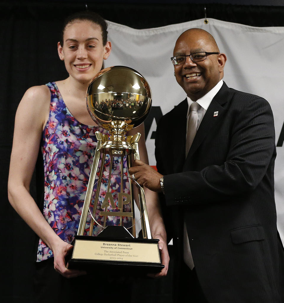Assistant Sports Editor, South Region Oscar Dixon presents the Associated Press college basketball player of the year trophy to Connecticut's Breanna Stewart at the women's Final Four of the NCAA college basketball tournament, Saturday, April 5, 2014, in Nashville, Tenn. (AP Photo/Mark Humphrey)
