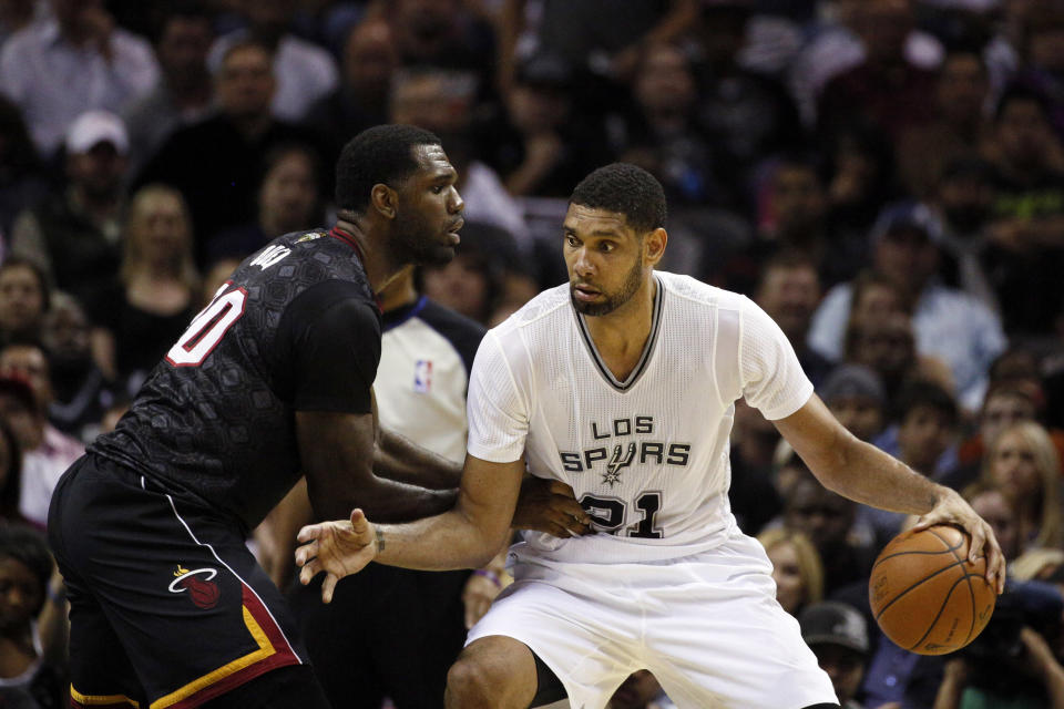 Mar 6, 2014; San Antonio, TX, USA; San Antonio Spurs forward Tim Duncan (21) is defended by Miami Heat center Greg Oden (20) during the first half at AT&T Center. (Soobum Im-USA TODAY Sports)