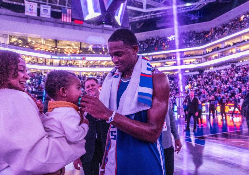 Sacramento Kings guard De’Aaron Fox (5) celebrates his team’s victory against the Golden State Warriors with his wife Recee Caldwell and son Reign after the game on Tuesday. 