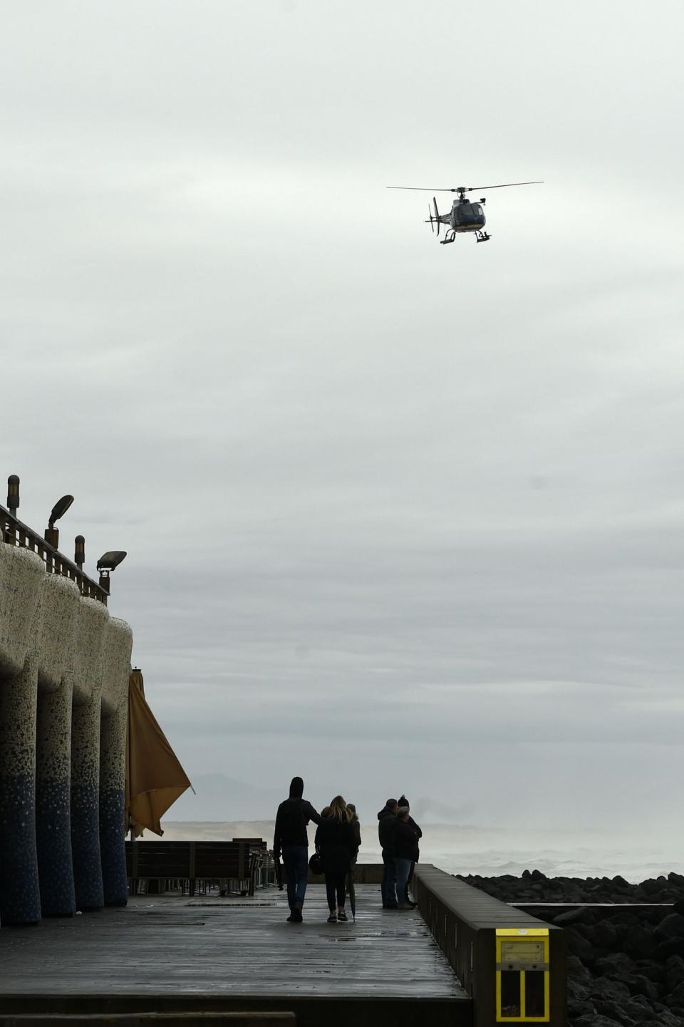 A gendarmerie helicopter flies over the beach on Monday in Capbreton, south-western France (AFP via Getty Images)