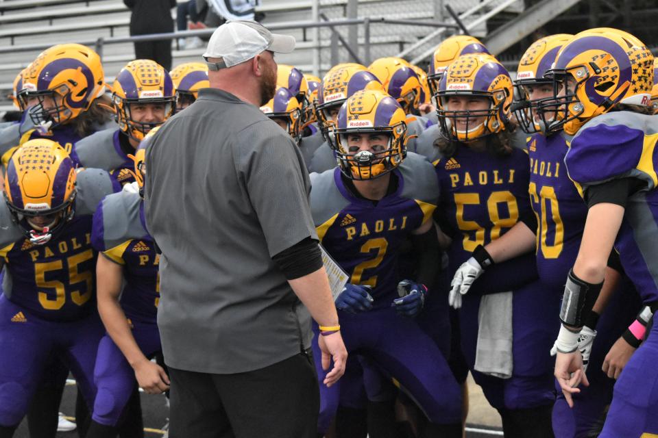 Paoli head coach Neil Dittmer pumps his players up before they take the field against Union County.
