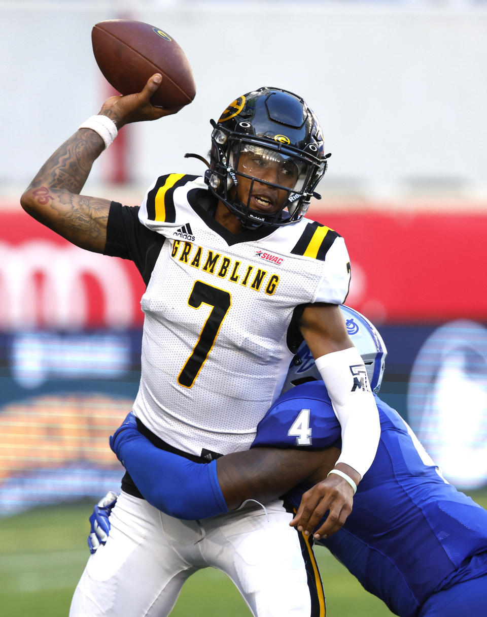 Grambling quarterback Myles Crawley (7) is tackled by Hampton linebacker Qwahsin Townsel (4) during the second half of an NCAA college football game Saturday, Sept. 2, 2023, in Harrison, N.J. (AP Photo/Noah K. Murray)