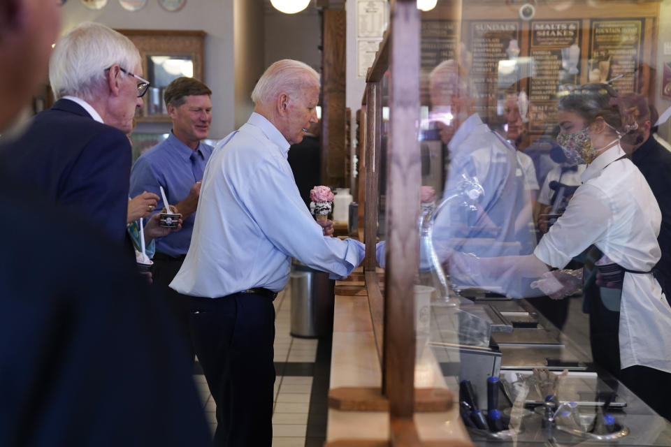 President Joe Biden buys ice cream at The Pearl Ice Cream Parlor Tuesday, June 29, 2021, in La Crosse, Wis., as Wisconsin Gov. Tony Evers, left, watches (AP Photo/Evan Vucci)