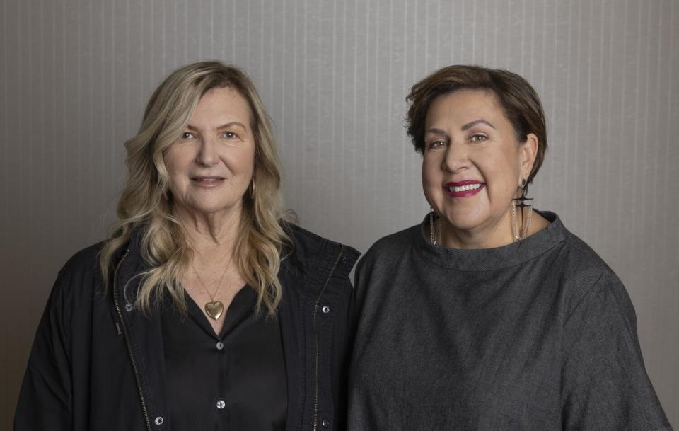 Two women stand side by side for a portrait.