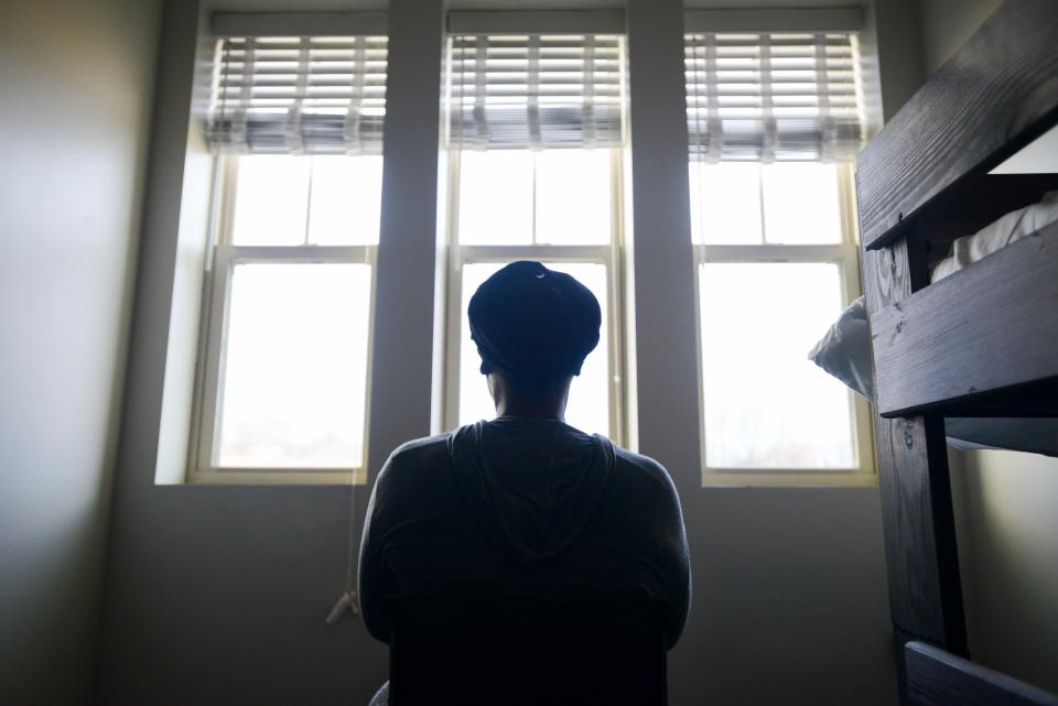 Krystle Terry stares outside a window as she stays at The Dream Center in Jackson, Tenn., on Thursday, Dec. 21, 2023. Terry, alongside her two children, left her home following a domestic violence-charged relationship.