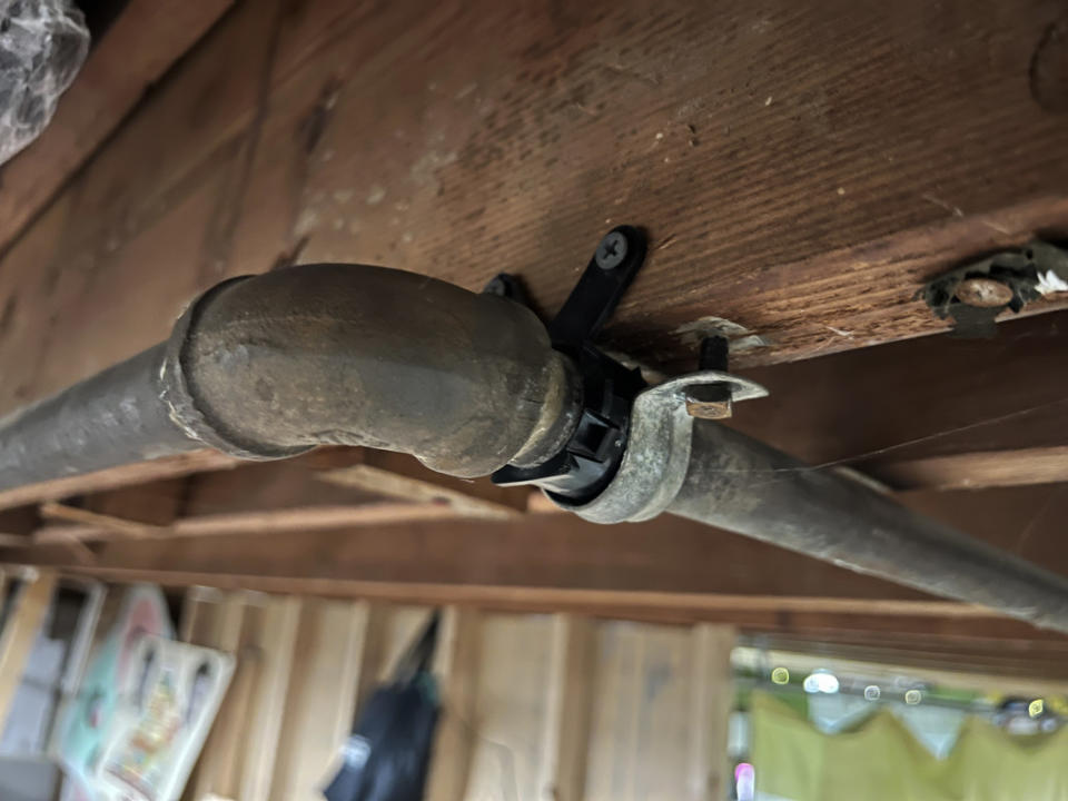 Use plastic tube insulators to create a buffer between the metal pipe fittings and your ceiling rafters.<p>Emily Fazio</p>