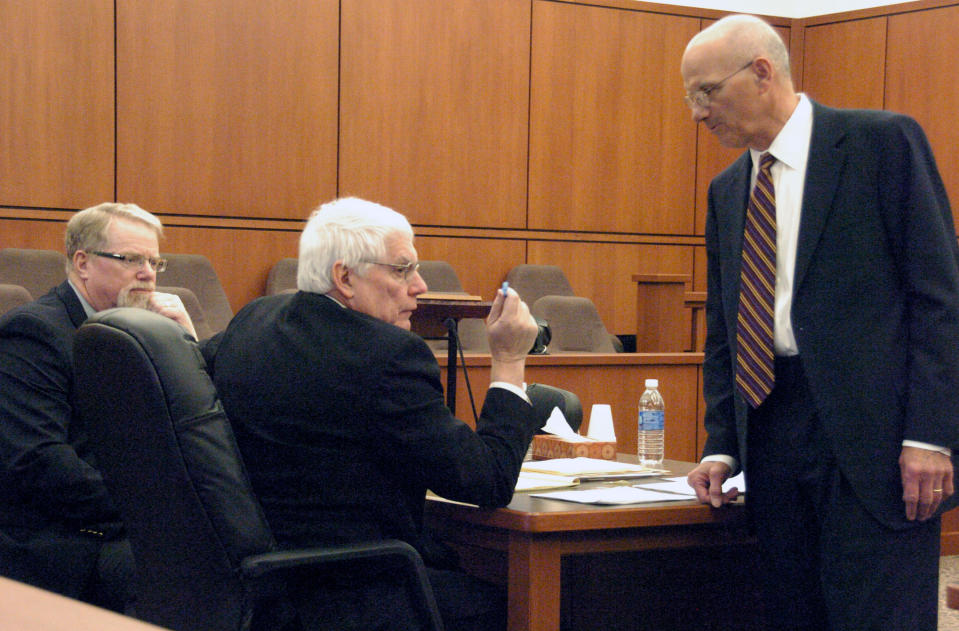 Defense attorney Al Avignone, right, speaks with Richland County Attorney Mike Weber, center, at the competency hearing for murder suspect Michael Keith Spell on Tuesday, March 25, 2014 in Sidney, Mont. Deputy County Attorney T.R. Halvorson, left, looks on. A state psychiatrist testified that Spell is fit for trial. (AP Photo/Matthew Brown)