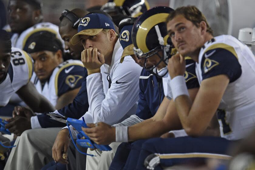 Jared Goff (16) sits on the bench in street clothes, hand on chin, while the Rams played at the San Francisco 49ers in 2016.