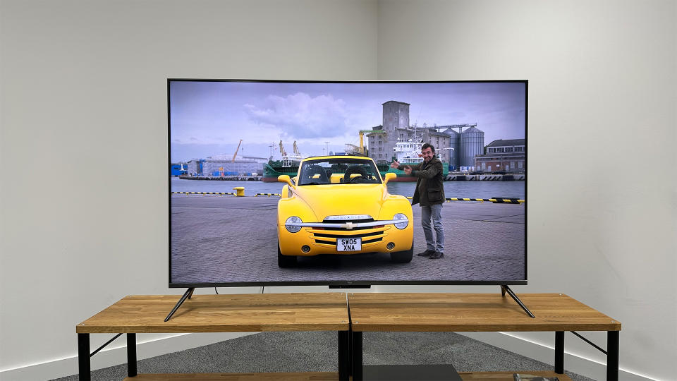 Amazon Fire TV Omni QLED on a wooden stand with an image from The Grand Tour on the screen