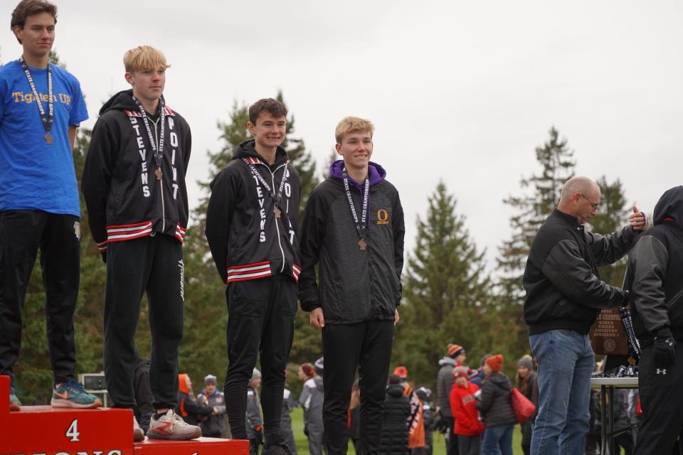 Oconomowoc's James Lennington (far right) led area boys by finishing 10th.