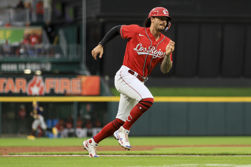 Cincinnati Reds' Jonathan India scores a run on a double by Kyle Farmer during the first inning of a baseball game against the Milwaukee Brewers in Cincinnati, Friday, Sept. 23, 2022. (AP Photo/Aaron Doster)