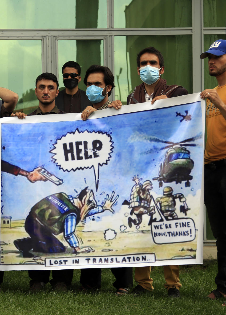 In this Friday, April 30, 2021, photo former Afghan interpreters hold banner during a protest against the U.S. government and NATO in Kabul, Afghanistan. (AP Photo/Mariam Zuhaib)