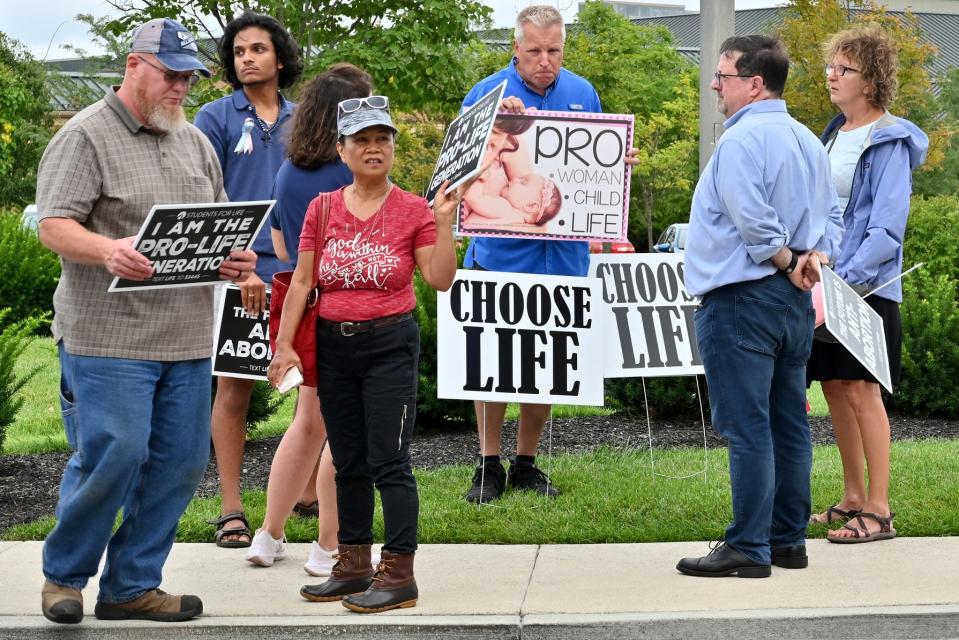 Anti-abortion rights advocates gathered outside of the Mason Municipal Center before a Mason city council meeting on Monday, August 9, 202. At the last meeting on July 12, council member T.J. Honerlaw proposed to introduce an abortion ban “very soon”. However, there was no mention of an abortion ban on the council’s agenda. 