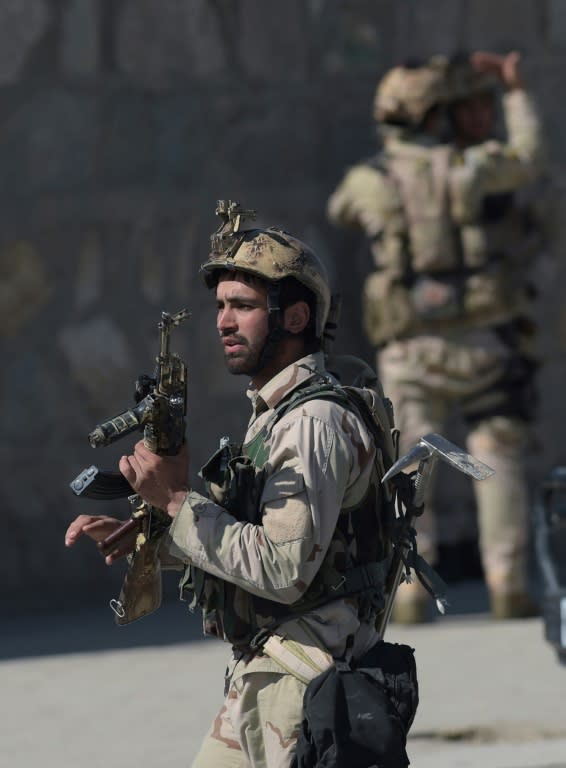 Afghan security forces arrive at the scene of a suicide car bombing in Kabul on March 1, 2017