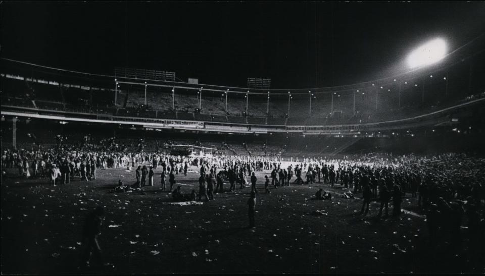 The crowd mills around the outfield at County Stadium in Milwaukee after Pink Floyd left the stage on June 15, 1977. About 60,000 people attended the concert, two years after Pink Floyd played before 54,000 in the same ballpark.