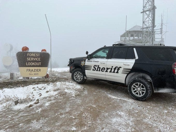 A patrol vehicle from the Ventura County Sheriff's Lockwood Valley station parks near a U.S. Forest Service lookout dusted in snow in 2022. Deputies rescued a 65-year-old on Tuesday who was stranded for four days after gates were locked for the winter.