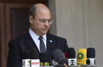 Rio de Janeiro Governor Wilson Witzel pauses as he speaks to journalists at the Laranjerias palace in Rio de Janeiro, Brazil, Tuesday, May 26, 2020. Brazil's Federal Police searched Witzel's official residence on Tuesday, part of an investigation into the alleged embezzlement of public resources in the state's response to the COVID-19 pandemic. (AP Photo/Silvia Izquierdo)