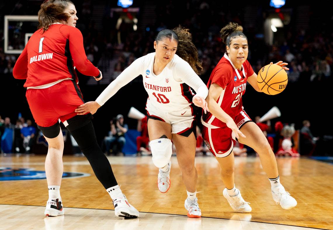 NC State’s Madison Hayes drives against Stanford’s Talana Lepolo in first half NCAA Sweet 16 action in Portland.