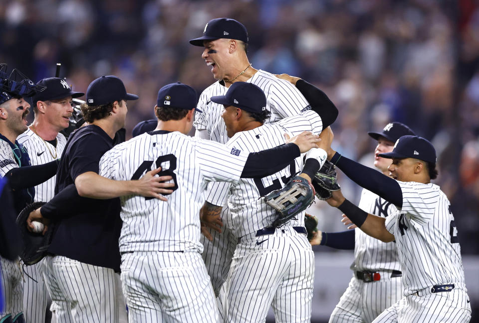 The New York Yankees, including Aaron Judge, center top, celebrate after clinching the American League East title in a baseball game against the Baltimore Orioles, Thursday, Sept. 26, 2024, in New York. (AP Photo/Noah K. Murray)