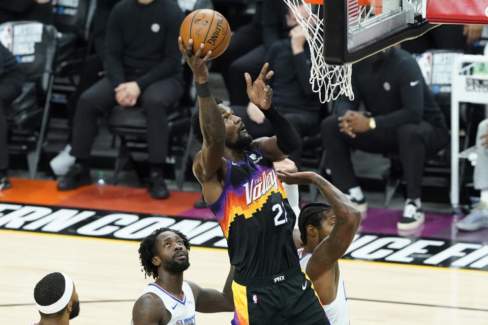 Phoenix Suns center Deandre Ayton, middle, shoots against the Los Angeles Clippers during the first half of Game 2 of the NBA basketball Western Conference Finals, Tuesday, June 22, 2021, in Phoenix. (AP Photo/Matt York)