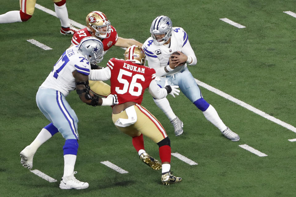 Dallas Cowboys quarterback Dak Prescott, right, is pressured by San Francisco 49ers defensive end Samson Ebukam (56) and defensive end Nick Bosa before being sacked by Bosa during the first half of an NFL wild-card playoff football game in Arlington, Texas, Sunday, Jan. 16, 2022. (AP Photo/Roger Steinman)