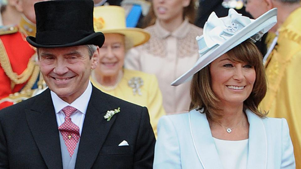 Carole Middleton in a blue coat dress and her husband Michael in a suit at the royal wedding