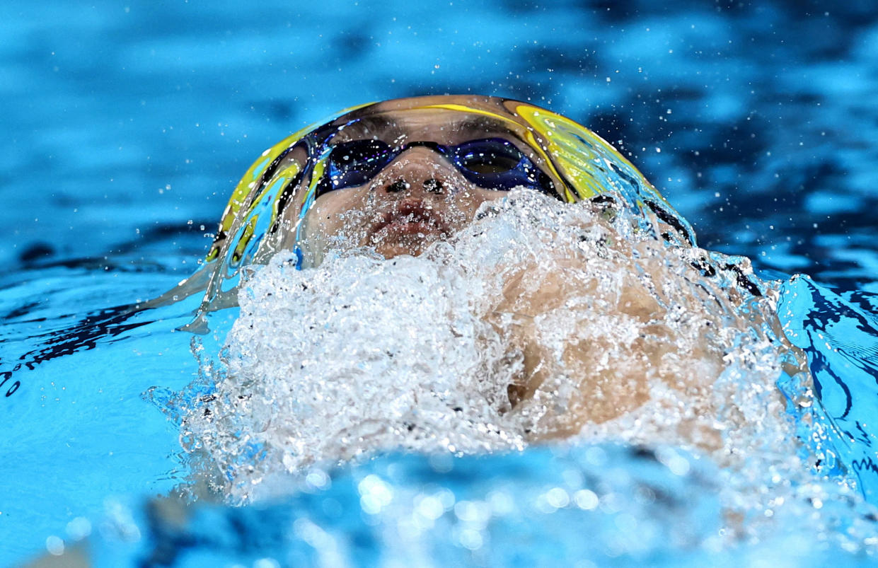 The semi-submerged face, including cap and goggles, of Jiayu Xu of China during the men's 100m backstroke heats. 