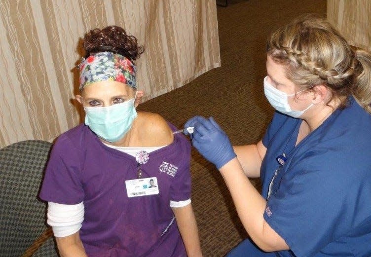 Vicki Zimmerman, an environmental services associate who cleans patient areas at HSHS St. Nicholas Hospital, was one of the first to receive a COVID-19 vaccine at HSHS St. Nicholas Hospital on Dec. 29.