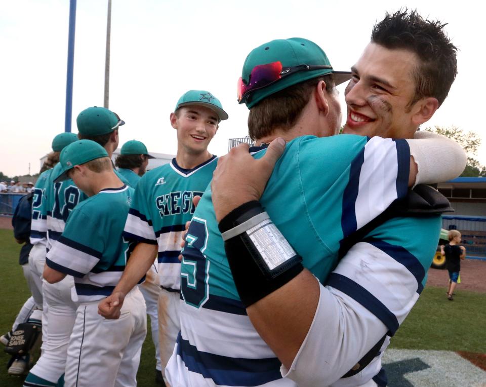 Siegel's Tyler Kirkland (9) and Alex Carignan (13) embrace as they celebrate winning the 2016 TSSAA Class AAA state baseball championship.