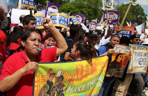 People protest in front of the US Supreme Court as it hears arguments on Arizona's controversial immigration law