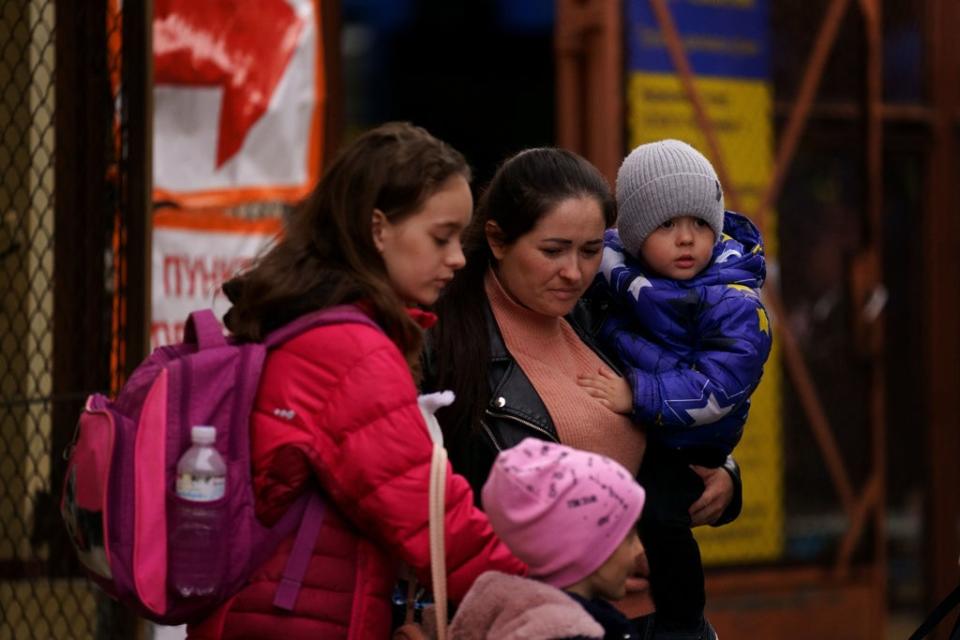 A Ukrainian family walk out of the customs office at Przemysl Glowny train station in Poland (Victoria Jones/PA) (PA Wire)