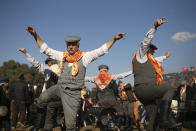 Men dance during Turkey's largest camel wrestling festival in the Aegean town of Selcuk, Turkey, Sunday, Jan. 16, 2022. They were competing as part of 80 pairs or 160 camels in the Efes Selcuk Camel Wrestling Festival, the biggest and most prestigious festival, which celebrated its 40th run. (AP Photo/Emrah Gurel)