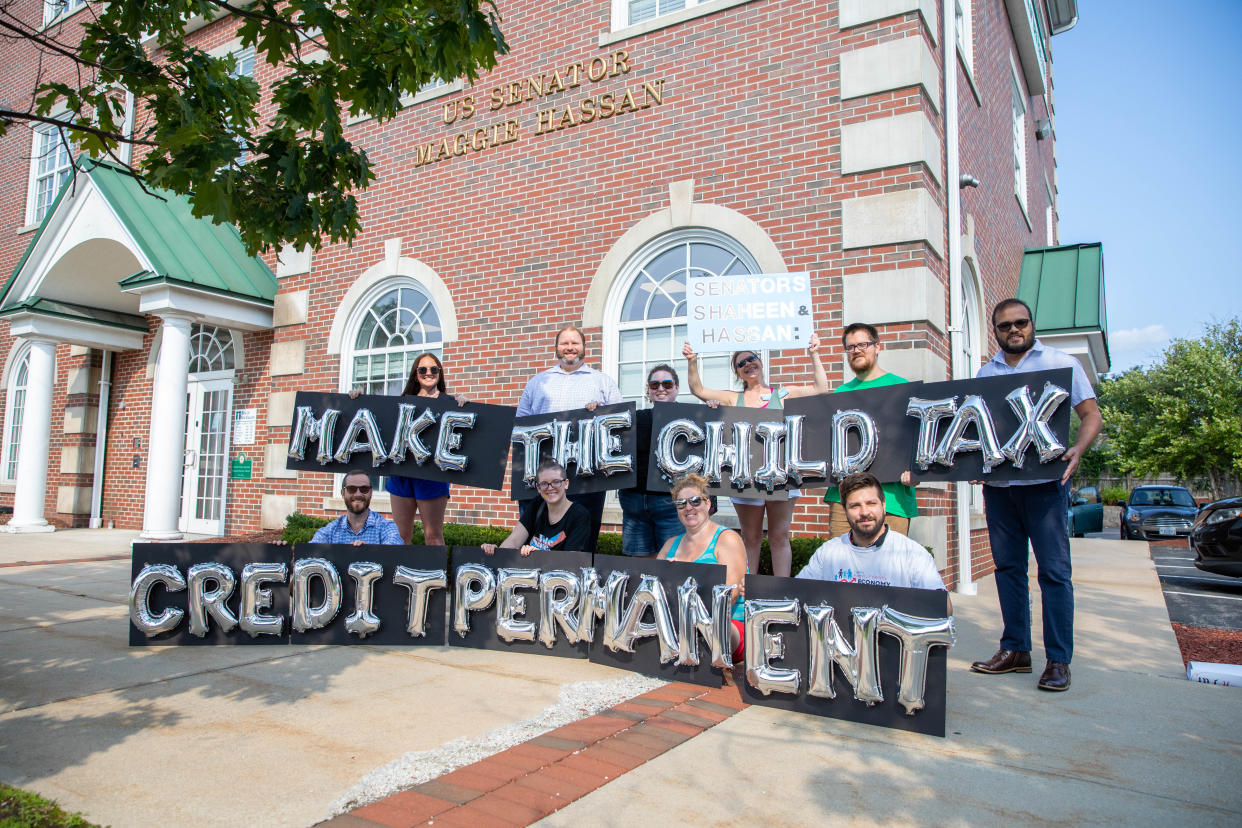 MANCHESTER, NH - SEPTEMBER 14: New Hampshire parents and other supporters gather outside of Senator Hassan's Manchester office to thank her for child tax credit payments and demand they be made permanent on September 14, 2021 in Manchester, New Hampshire.  (Photo by Scott Eisen/Getty Images for ParentsTogether)