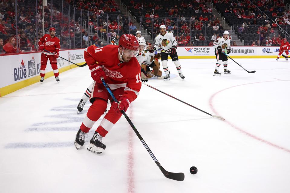 Red Wings forward Filip Zadina tries to control the puck against the Blackhawks during a preseason game on Monday, Oct. 4, 2021, at Little Caesars Arena.