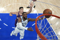 Minnesota Timberwolves guard Mike Conley, front, shoots as Phoenix Suns guard Grayson Allen defends during the second half of Game 2 of an NBA basketball first-round playoff series Tuesday, April 23, 2024, in Minneapolis. (AP Photo/Abbie Parr)