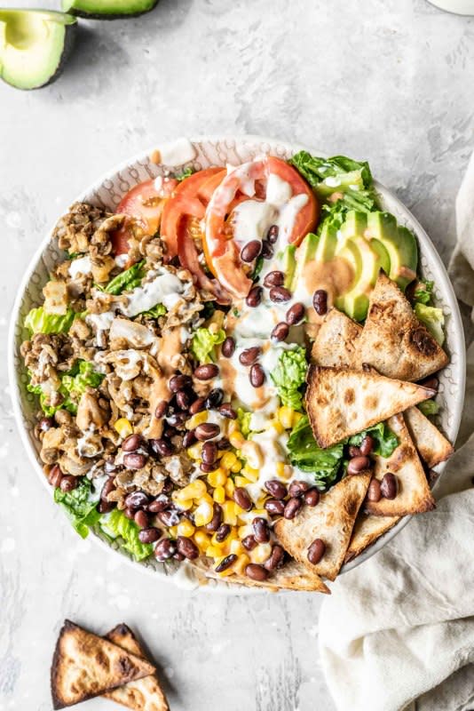 <p>Running on Real Food</p><p>This vegan taco salad features delicious lentil taco meat, tortilla chips, avocado, tomato, corn, beans and quick and easy vegan sour cream. </p><p><strong>Get the recipe: <a href="https://runningonrealfood.com/vegan-taco-salad/" rel="nofollow noopener" target="_blank" data-ylk="slk:Vegan Taco Salad;elm:context_link;itc:0;sec:content-canvas" class="link ">Vegan Taco Salad</a></strong></p>