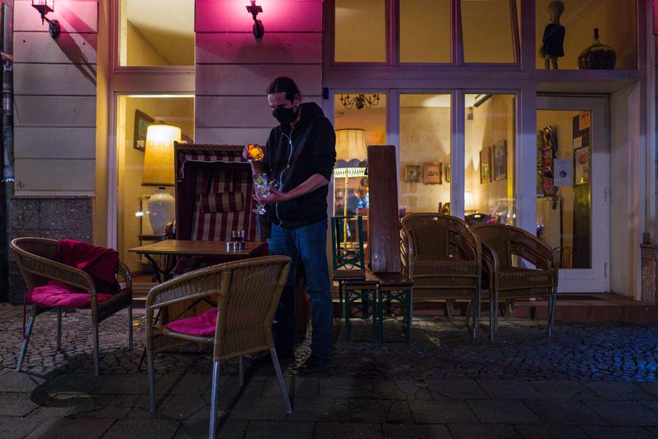 A bar owner closes up at a bar in Berlin's Prenzlauer Berg district on October 10, 2020. - Stolz, along with other bar owners in Berlin, has challenged local authorities over the re-introduction of a curfew for bars in the capital, which are, from October 10 onwards, forbidden to operate between 11 PM and 6 AM. (Photo by JOHN MACDOUGALL / AFP) (Photo by JOHN MACDOUGALL/AFP via Getty Images)