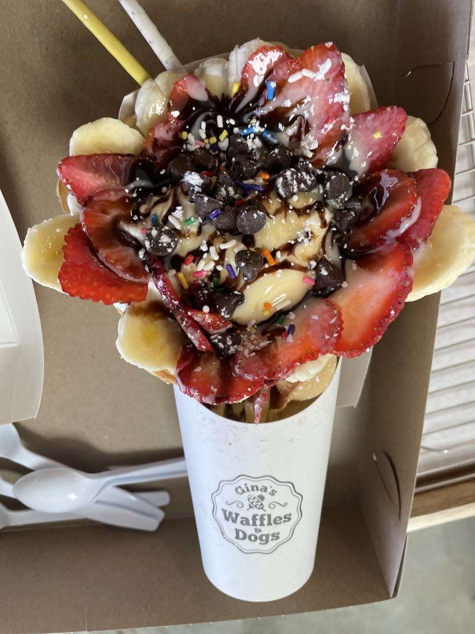 Bubble Waffle filled with ice cream, bananas and strawberries and topped with chocolate sauce, sprinkles and chocolate chips.