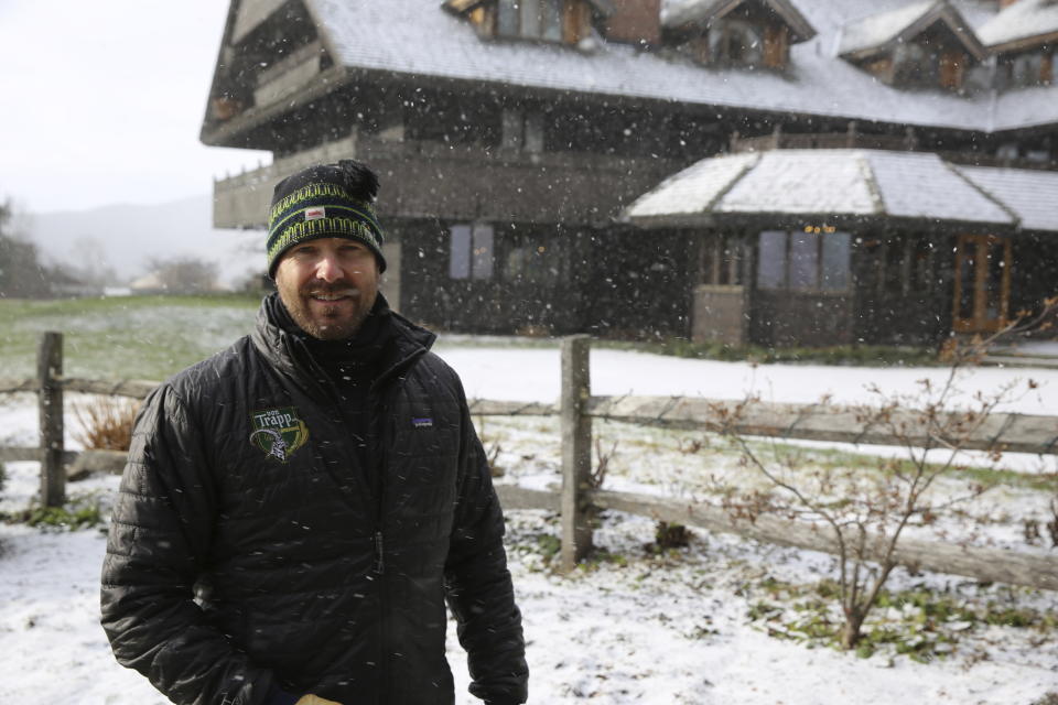 Sam von Trapp , the executive vice president of the Trapp Family Lodge poses outside the lodge on Tuesday, Dec. 15, 2020 in Stowe, Vt. Quarantine rules imposed in an attempt to stop the spread of novel coronavirus are affecting business during the normally busy holiday season. He says the rules are frustrating but be understands the need for them. He's looking forward to a time when the pandemic is over. (AP Photo/Wilson Ring)