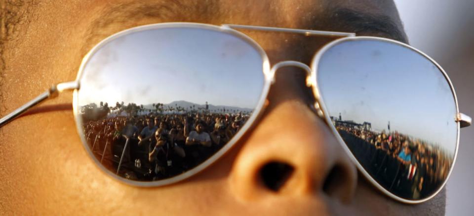 <div class="inline-image__caption">Concert goers are reflected in the sunglasses of a security guard as "The Specials" perform at the Coachella Music Festival in Indio, California, April 16, 2010. REUTERS/Mario Anzuoni (UNITED STATES - Tags: ENTERTAINMENT) - GM1E64H0VBE01</div> <div class="inline-image__credit">Reuters</div>