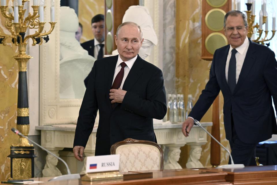 In this photo provided by Photo host Agency RIA Novosti, Russian President Vladimir Putin, left, and Russian Foreign Minister Sergey Lavrov arrive to attend a meeting with a delegation of African leaders and senior officials in St. Petersburg, Russia, Saturday, June 17, 2023. Seven African leaders — presidents of Comoros, Senegal, South Africa and Zambia, as well as Egypt's prime minister and top envoys from the Republic of Congo and Uganda — traveled to Russia on Saturday a day after visiting Ukraine on a mission to try to help end the hostilities. (Pavel Bednyakov/Photo host Agency RIA Novosti via AP)