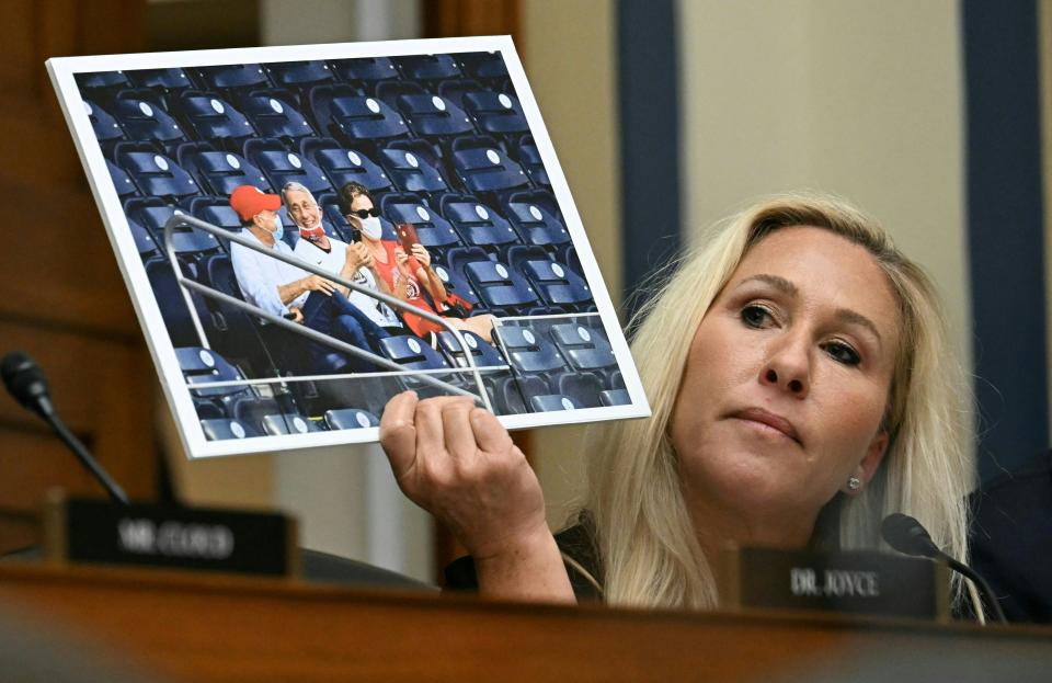 US Representative Marjorie Taylor-Greene, Republican of Georgia, holds up an image of Dr. Anthony Fauci, former director of the National Institute of Allergy and Infectious Diseases, as she questions him during a House Select Subcommittee on the Coronavirus Pandemic hearing on Capitol Hill, in Washington, DC, June 3, 2024 (AFP via Getty Images)