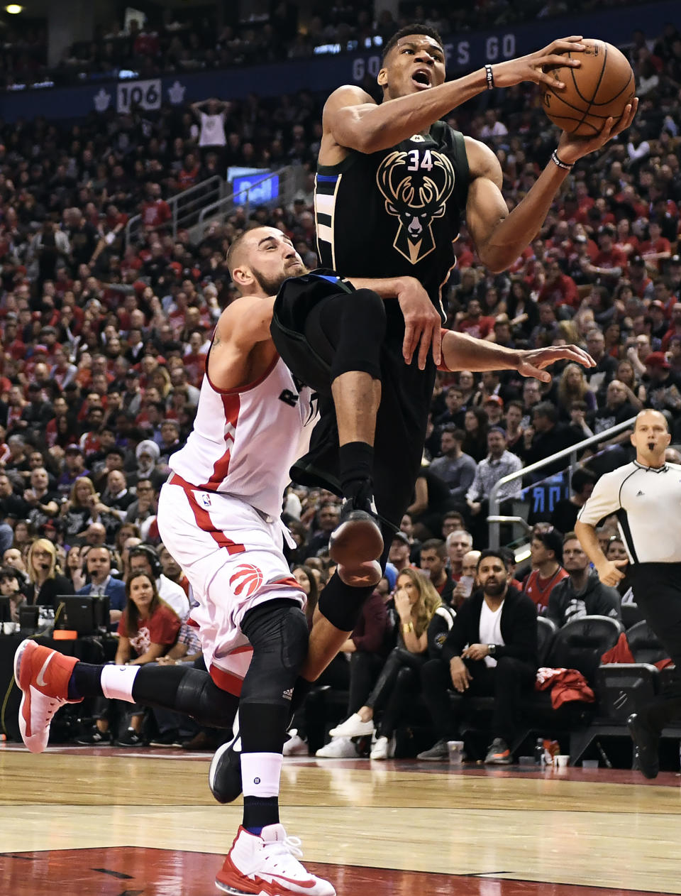 Milwaukee Bucks forward Giannis Antetokounmpo (34) drives past Toronto Raptors center Jonas Valanciunas (17) during second-half NBA playoff basketball game action in Toronto, Saturday, April 15, 2017. (Frank Gunn/The Canadian Press via AP)