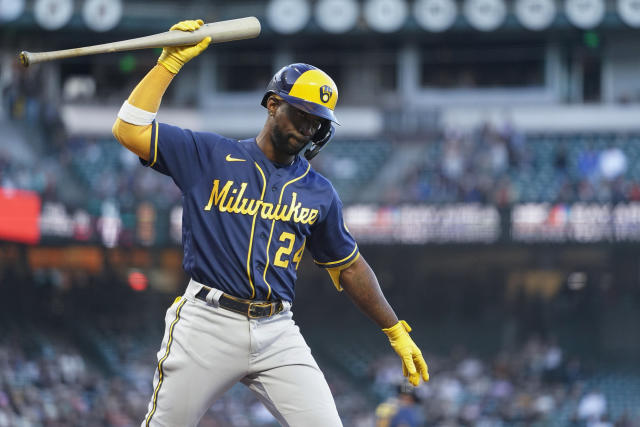 Milwaukee Brewers designated hitter Andrew McCutchen reacts as he