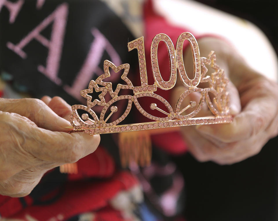 COVID-19 survivor Irma Gooden holds her tiara while celebrating her 100th birthday at Westbury Medical Care & Rehabilitation on Tuesday, June 16, 2020, in Jackson, Ga. Gooden is one of 84 residents at Westbury Medical Care and Rehab who tested positive for COVID-19 and has since recovered. Westbury is one of the hardest-hit senior care homes in the state, with 34 deaths among its 123 residents who tested positive for COVID-19. More than three dozen workers at the facility also tested positive and one died. Statewide, more than half of the state's senior care homes have had at least one confirmed coronavirus case among residents or staff. As of Monday, 6,402 long-term care residents have tested positive and 1,139 have died, according to reports made to the Georgia Department of Community Health. More than 2,800 long-term care workers statewide have also tested positive. (Curtis Compton/Atlanta Journal-Constitution via AP)