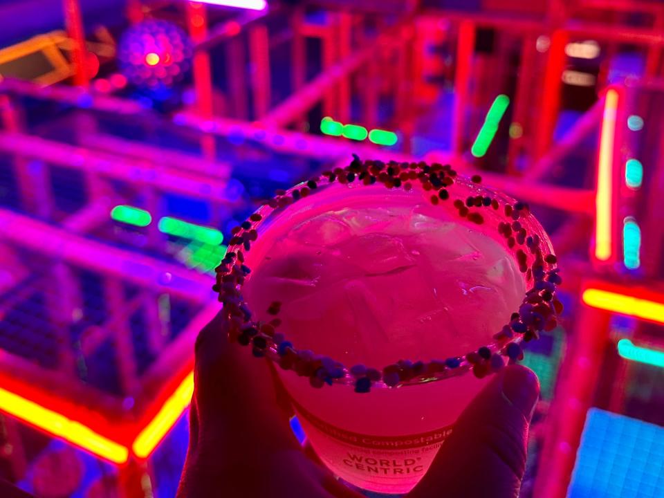 a cocktail in a neon-lit area