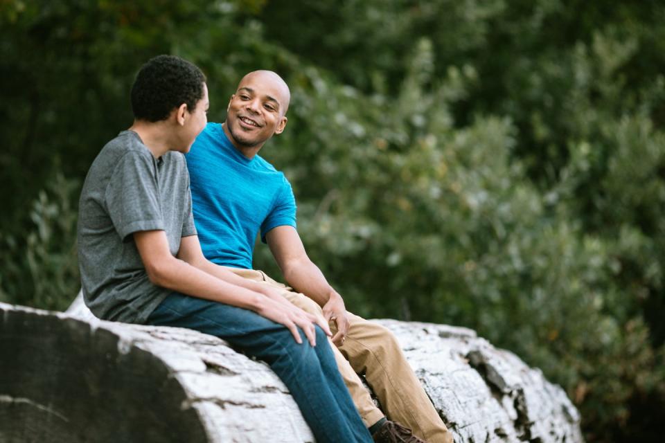 a man talks to his son on a beach in washington state, enjoying the beauty of the pacific northwest