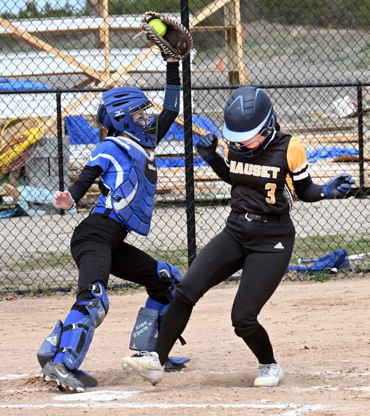 BOURNE 4/18/23  Upper Cape Tech catcher Lucy Pesta takes the throw forcing Kaylee Davis of Nauset at home.