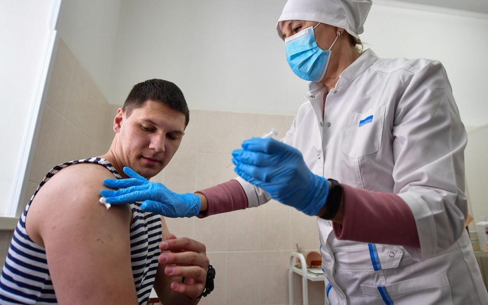 A student of the Makarov Pacific Higher Naval School is vaccinated with the first component of the Gam-COVID-Vac (Sputnik V) COVID-19 vaccine - Yuri Smityuk /TASS